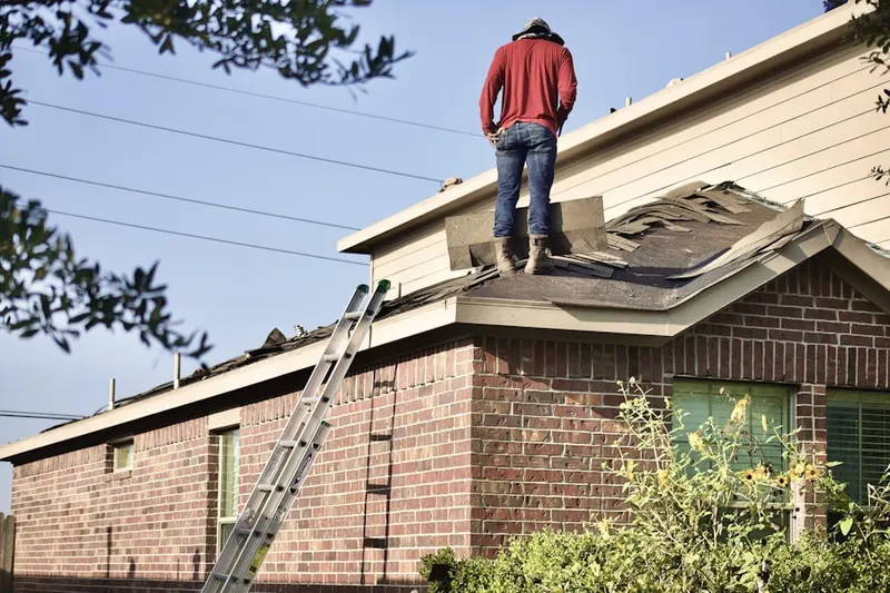 Professional roofer working on a residential roof in Dover Meadows